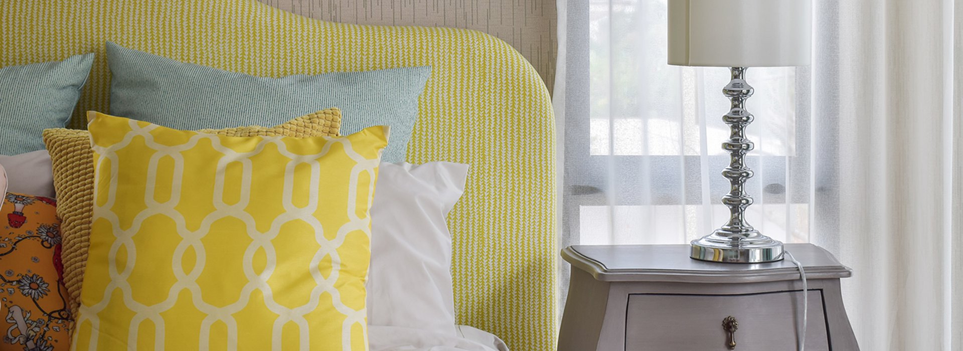 pattern pillows on classic style bed and reading lamp